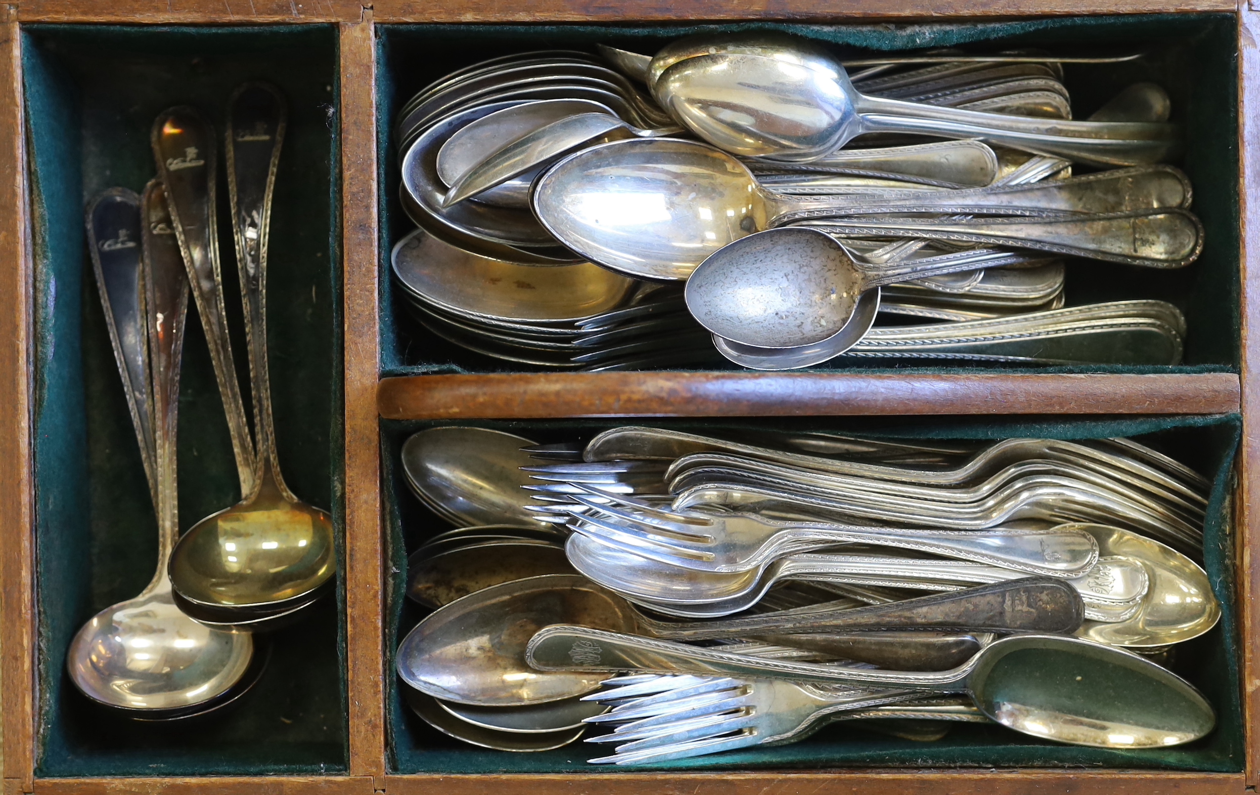 An Elkington & Co. plated canteen of cutlery, each piece engraved with a greyhound crest and two mahogany cutlery boxes